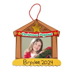 a christmas ornament hanging on a wall with a photo in the front and bottom