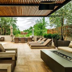 an outdoor living area with couches and tables