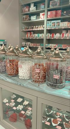 a display case filled with lots of different types of candies and candy in glass containers