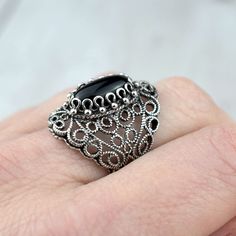 Black Onyx 925 Silver Lace Ring Artisan Made Handcrafted Filigree Art Lace Statement Ring Ring Face Length is 0.65 inches and Width is 0.30 inches Black Onyx Gemstone is 7X14 mm oval cabochon cut. This metal embroidery filigree ring is oxidized and highly polished. Comes with velvet pouch and luxurious gift box. Filigree is made of delicate metal strands that have been skillfully fashioned to create an outstanding combination of old and modern art. Originating in Mesopotamia, Anatolia. It is mad Black Sterling Silver Filigree Ring As A Gift, Ornate Black Sterling Silver Rings, Black Cabochon Jewelry For Wedding, Black Cabochon Wedding Jewelry, Ornate Black Rings As Gift, Ornate Black Rings For Gifts, Ornate Black Rings For Gift, Ornate Black Filigree Jewelry, Black Ring With Intricate Design