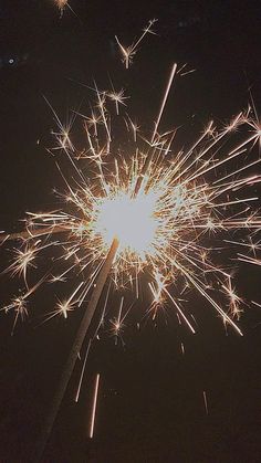 fireworks are lit up in the night sky with bright sparks coming out from their top