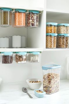 the shelves are filled with cereals, cereal flakes and other food in containers