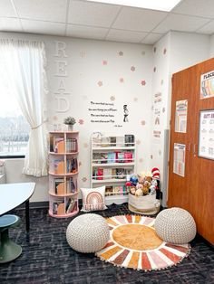 an office decorated in pink and white with bookshelves, desks, and stuffed animals