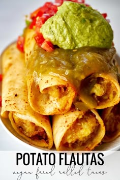 a plate filled with tortillas covered in sauce and guacamole