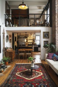 a living room filled with furniture next to a fire place stove top oven and lots of windows