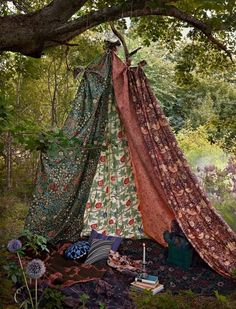 a teepee in the woods is covered with fabric