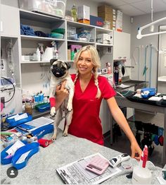 a woman holding a pug dog in a vet's office with tools on the counter