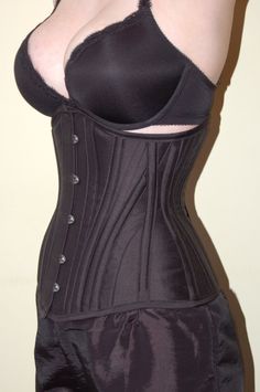 "Kiku's Hip Gore under bust corsets are based on a traditional longline pattern from the early 1900s, updated to a modern size range. They are typically cut with 14 panels, and 16 spiral steel bones, however sizes 34 and over may have more panels and spiral steel bones, while sizes 22 and under may be made with slightly fewer spiral steel bones. This particular corset is our most versatile and best selling item. Can be worn under or over clothes to enhance any figure. The Hip Gore is a popular c Under Bust Corset, Waist Belts, Steel Boned Corsets, Boned Corsets, Corset Fashion, Lace Tights, Waist Training Corset, Corsets And Bustiers, Underbust Corset