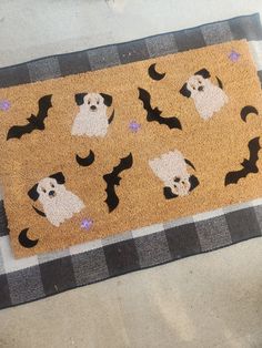 a door mat with dogs and bats on it