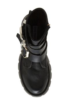 Bring a bit of moto edge to your everyday style in this lug-sole bootie accented with a trio of bold buckle straps. 2 1/4" heel 6 3/4" shaft Side zip closure Leather upper/synthetic lining and sole Imported Grunge High-top Moto Boots With Lug Sole, Rugged High-top Moto Boots With Lug Sole, Rugged Lace-up Moto Boots With Lug Sole, High-top Moto Boots With Lug Sole And Medium Width, Black Ankle-high Moto Boots With Lug Sole, Lug Sole, Everyday Style, Bootie, Side Zip