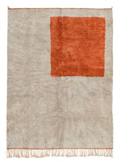 an orange and white rug with fringes on the bottom, in front of a white background