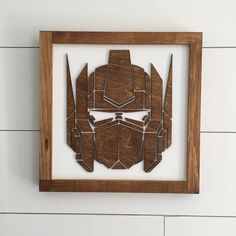 a wooden cutout of a helmet is mounted on the wall