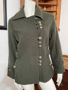 "Celtic button closure design. Beautiful dark green color. 100% wool. Very classy look.  Chest (pit to pit): 20\" Shoulder:16\" Length: 29\" Sleeve: 22\" In excellent condition. No flaws noticed See pictures" Cheap Vintage Outerwear With Button Closure, Fitted Khaki Pea Coat With Button Closure, Fitted Olive Outerwear With Buttons, Green Pea Coat For Fall With Button Closure, Green Pea Coat With Buttons For Fall, Green Pea Coat With Button Closure For Fall, Green Pea Coat For Fall, Khaki Wool Outerwear With Buttons, Fitted Dark Green Outerwear For Fall