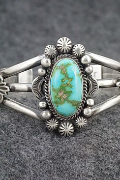 This stunning Sonoran Gold turquoise and sterling silver bracelet was made by Navajo silversmith Rosita Calladitto. The back is signed R Calladitto and stamped Sterling.Size: 5 5/8" (will fit up to a 6 5/8" wrist)Gap: 1"Width: 1 5/8"Cuff Width: 1/2"Free shipping on all orders! We ship with USPS and always include tracking. All orders ship within a day of payment.Returns are accepted up to 30 days after you receive your order. Just send us a message. Our shop offers cash back or store credit. The Western Style Bracelet Jewelry Gift, Western Style Bangle Jewelry Gift, Western Style Bangle Jewelry As Gift, Western Style Bangle As Gift, Southwestern Oval Bracelets As Gift, Elegant Turquoise Engraved Sterling Silver Bracelet, Elegant Engraved Turquoise Sterling Silver Bracelet, Southwestern Style Oval Bracelets For Gifts, Southwestern Style Oval Bracelets As Gift