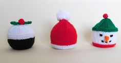 three knitted hats with snowmen on them, one is red and the other is white