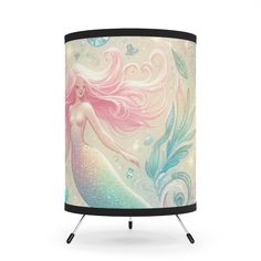 a lamp shade with a mermaid on it's side and an image of a pink hair