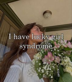 a woman holding a bouquet of flowers with the words, i have lucky girl syndrome