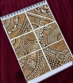 a spiral notebook with intricate designs on it