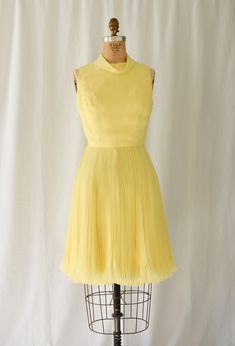 1960s Dress | Joseph Magnin  | Vintage 60s Dress Lemon Yellow Chiffon Cocktail Party Dress Accordion Pleats  DETAILS:  *1960's era *Lemon yellow poly chiffon fit and flare cocktail dress *Fitted bodice *Bias band roll collar  *Sleeveless *Accordion pleat skirt with lettuce hem *Fully lined *Back lapped zipper LABEL: Joseph Magnin. Joseph was the son of the owners of the upscale I Magnin department stores and fashion label. He struck out on his own and had several stores as well. CONDITION: Excellent. Small faint mark on front bodice. Does not distract. Zoom in on third photo.  MEASUREMENTS:  Bust=34" Waist= 26" Hip= 38"  Length from high point shoulder to hem= 38" Compare with your own measurements + ease or compare with similar garments in your closet.  SHIPPING: This item will ship via U Fitted Chiffon Vintage Dress For Party, Retro A-line Cocktail Dress, Vintage Pleated Party Dresses, Vintage Fitted Chiffon Dresses, Fitted Vintage Chiffon Dresses, Vintage Sheer Chiffon Dress, Retro Sleeveless Cocktail Vintage Dress, Mod Spring Party Dress, Mod Style Spring Party Dresses