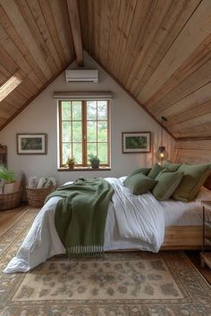 a bedroom with wooden walls and ceiling, has a bed covered in green pillows and blankets