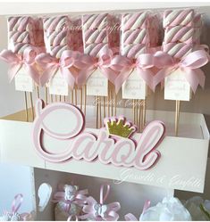 pink and white candy sticks with the word carol on them