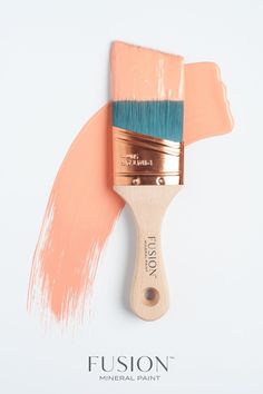 a paintbrush with pink and blue bristles on it