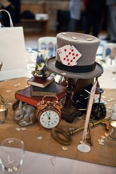 a table topped with lots of different types of items on top of a cloth covered table