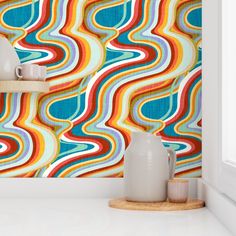 a colorful wallpaper with wavy lines on the walls and vases next to it