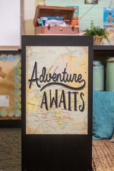 a sign that says adventure awaits in front of a map