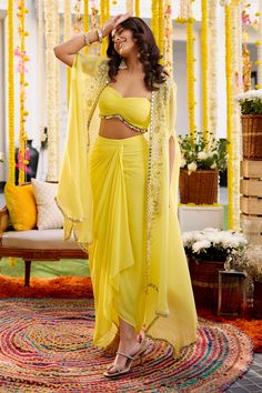 Buy Yellow Georgette Embroidery Mirror Cape Open Draped Skirt Set For Women by Label Sanya Gulati Online at Aza Fashions. Yellow Dhoti Dress, Dhoti Cape Outfit, Engagement Dress For Women Indian, Dhoti Dress For Women Wedding, Dress Indian Style Wedding, Haldi Dress For Bride Sister, Weeding Dress Outfits Women, Dhoti Skirt Outfits, Pithi Outfit