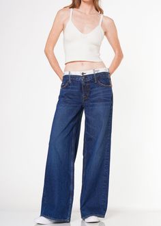 These contemporary wide baggy jeans feature a double waistband and belt loops in a super dark wash for a modern, stylish look. This piece promises to become a staple in your wardrobe. Model is 5'10" wearing size 26. Approx. Front rise: 10.5" Inseam: 31.5"Approx. Knee: 24.25" Leg opening: 25" 100% CottonMade in USA Fits true to size. Super Dark, Baggy Shorts, Jumpsuit Jacket, Kick Flares, Baggy Jeans, Men's Collection, Denim Top, New Product, Top Styles