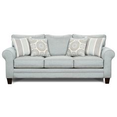 a light blue couch with two pillows on the back and one pillow that is in front of it