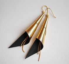 Gold plated cone and genuine champagne gold leather earrings. Gold colored earrings hook. ------ ▲ ▲ ▲ ------SIZE: > length: 10 cmMATERIAL:> Gold plated> genuine lambskin leatherNickel free jewelry !COLOR: > Champagne> Gold------ ▲ ▲ ▲ ------Comes in its own handmade gift package, ready to be given as a present. (If you want to).------ ▲ ▲ ▲ ------Follow me:> Facebook:http://facebook.com/sarayana.fr> Official site:http://www.sarayana.fr------ ▲ ▲ ▲ ------Please feel free to Elegant Leather Earrings For Gift, Elegant Leather Earrings As Gift, Elegant Leather Earrings Perfect For Gifts, Elegant Leather Dangle Earrings, Party Leather Dangle Earrings, Elegant Leather Dangle Jewelry, Leather Dangle Jewelry For Party, Elegant Leather Earrings With Ear Wire, Party Leather Dangle Jewelry