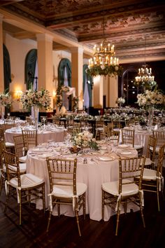 the tables are set with white and gold linens