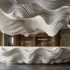 the interior of a building with wavy white paper covering it's walls and floors