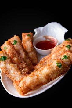 some fried food on a plate with dipping sauce