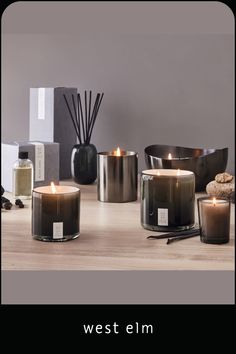 three candles sitting on top of a wooden table