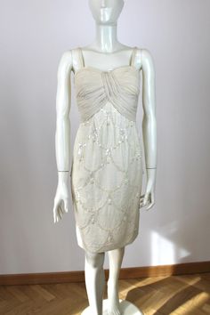 Seductive 1950s Off White Silk Dress No brand or size tags, couture item Origin: Italy Fits like: S Measurements: Bust - 87cm/34,3" Waist - 72cm/28,3" Hips - 98cm/38,6" Shown on the mannequin with the following measurements: 87-61-90cm (34,3"-24"-35,4") Condition: Very Good, there were some light stains on the armpits but we have rearranged the pleats so they are much less noticeable. Vintage Embellished Silk Dress, Embroidered Fitted Cocktail Evening Dress, Fitted Cream Dress With Pearl Embroidery, Beige Party Dress With Pearl Embroidery, Fitted Silk Dress With Pearl Embroidery, Cream Evening Dress With Pearl Embroidery, 1950s Style Cream Party Dress, 1950s Cream Party Dress, Fitted Embellished Dress For Vintage Events