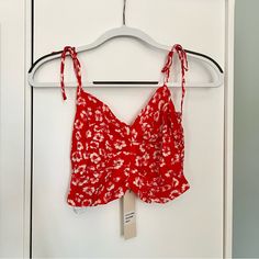 Dance & Marvel Crop Top In Size Medium. Red With White Flowers. Sweetheart Neck Line And Spaghetti Straps That Tie At Shoulders. Smocked Elastic Back. New With Tags And In Perfect Condition. Red Spaghetti Straps Top With Floral Print, Red Floral Print Spaghetti Strap Tops, Red Floral Print Top With Spaghetti Straps, Red Floral Print Tops With Spaghetti Straps, Red Spaghetti Straps Crop Top For Summer, Flirty Red Crop Top For Spring, Low Crop Top, Sweetheart Neck Line, Red Tube Top