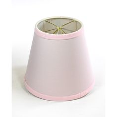 a pink lamp shade sitting on top of a white table