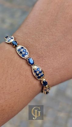 Looking for the perfect statement piece? This Sapphire 18k Gold Bracelet combines the beauty of vintage blue gemstones and a timeless gold design, making it a stunning choice for any September birthday or special occasion. A true treasure to cherish, this vintage bracelet is the ultimate gift for the woman in your life. Blue Jewelry With Jubilee Bracelet For Anniversary, Luxury Blue Gold Bracelet For Formal Occasions, Luxury Sapphire Bracelet Jewelry, Blue Oval Sapphire Diamond Bracelet, Round Sapphire Bracelet, Sapphire Jubilee Bracelet, Luxury Sapphire Bracelets For Anniversary, Luxury Sapphire Gemstone Bracelets, Classic Sapphire Bracelets For Anniversary