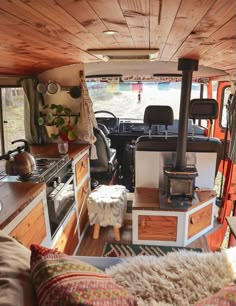 the interior of an old camper van with wood paneling on the walls and ceiling