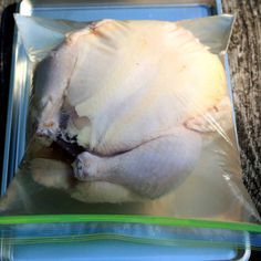 an uncooked chicken in a plastic bag