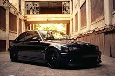 a black car parked in an alley way