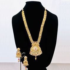 Elevate your traditional look with our Latest Gold Plated Long Necklace Set. Handcrafted with brass and luxurious gold plating, this set exudes elegance and sophistication. Perfect for sarees, lehengas, or suits, it will add a touch of glamour to any outfit. Complete with earrings, it's a must-have for every woman's jewelry collection. Handmade Item Material :Brass Gender: Women Color: Gold Plated Jewelry type: Long Necklace with Earrings. Gold Plated Chandbali Temple Jewelry Sets, Festive Temple Jewelry Sets In Gold Plated, Gold Plated Temple Jewelry Set For Puja, Festive Temple Jewelry Sets, Gold Plated, Festive Gold Plated Temple Jewelry Sets, Yellow Gold Jewelry Sets With Latkans For Festive Occasions, Temple Jewelry Gold Jewelry Set For Puja, Festive Yellow Gold Jewelry Sets With Latkans, Gold Temple Jewelry Set For Puja