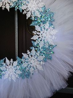 a white and blue wreath with snowflakes on it