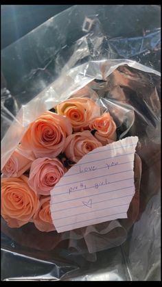 a bouquet of roses is wrapped in plastic and has a note attached to it that says i love you pretty girl