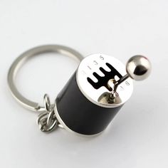 a black and silver keychain with a metal object on it