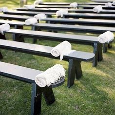 rows of benches with white towels on them