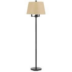 a floor lamp with a beige shade on the base and a black metal pole,